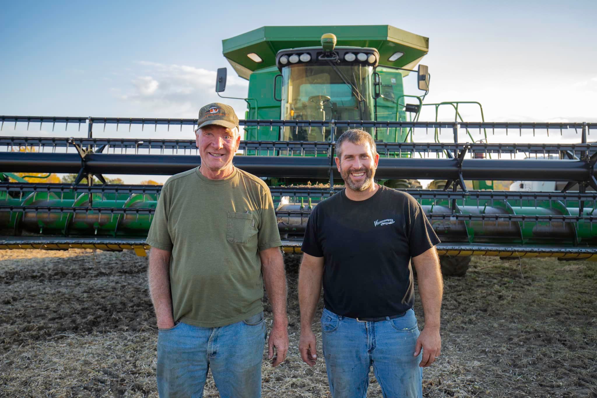 Photo of Charles and Nick Weisenberger in front of farm tractor.